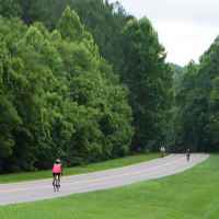 Group of cyclists passing by the War of 1812 Memorial site.