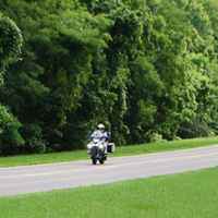 Group of motorcycles passing by the War of 1812 Memorial site.