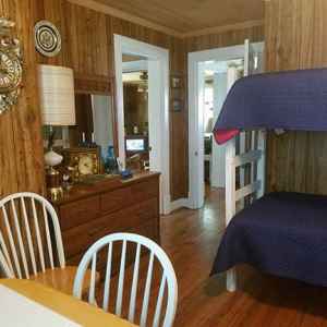 Patriotic Room with a full size bed, bunk twin beds, table and chairs and a baby crib.
