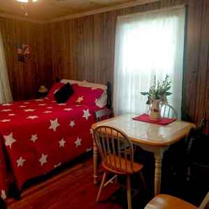 Patriotic Room with a full size bed, bunk twin beds, table and chairs and a baby crib.