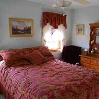 Upstairs guest room with queen bed.