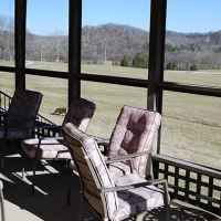 Screened-in porch wraps around three sides of the B&B.