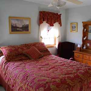 Upstairs guest room with queen bed.