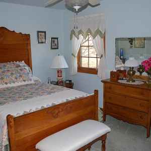 Upstairs guest room with double bed.