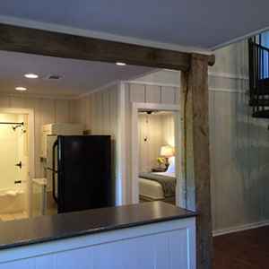 View into kitchen, bedroom, bathroom and spiral staircase leading to the loft.